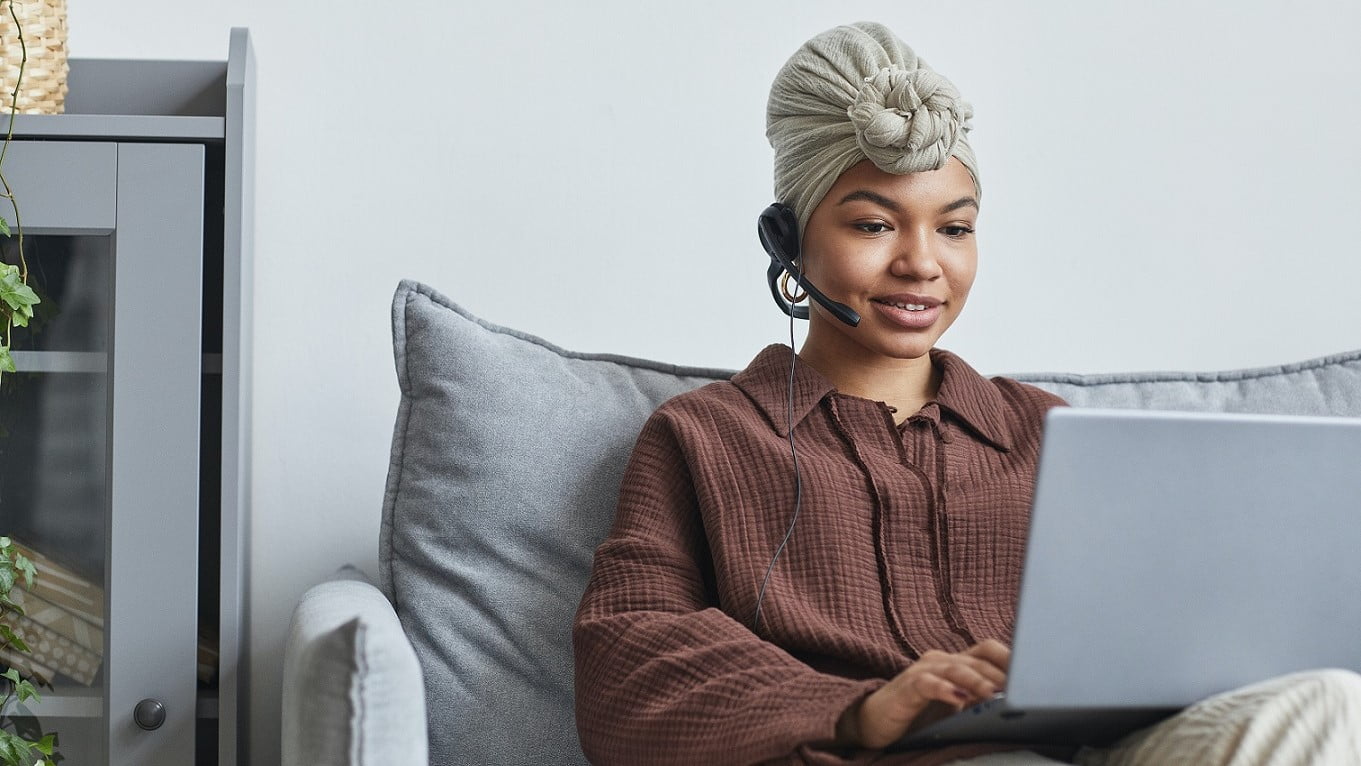 A woman confidently booking customer appointments on her laptop, representing the efficiency and expertise gained through the 12X Call Booking Training program from Shop On Fire.