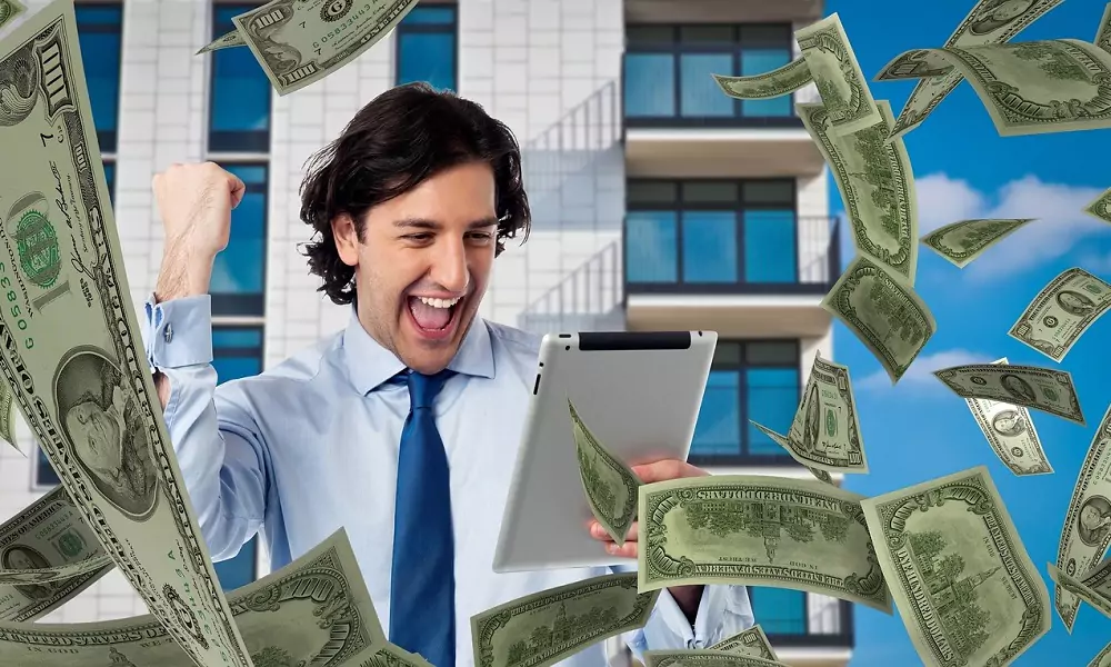 Excited businessman celebrating success, surrounded by flying dollar bills, representing the financial growth from lead generation services for service businesses.